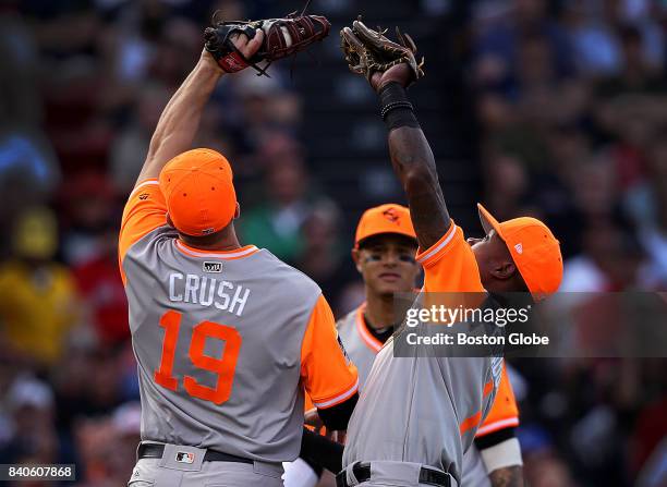 Baltimore Orioles first baseman Chris Davis and Baltimore Orioles shortstop Tim Beckham avoid a collision as Davis makes the catch of an infield pop...