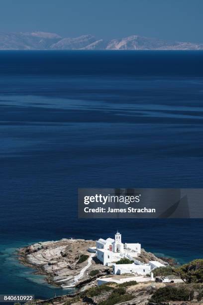 aerial shot of monastery of panagia chryssopigi (est 1650), with dark blue sea and island of antiparos in the background, sifnos, cyclades islands, greece - sifnos ストックフォトと画像