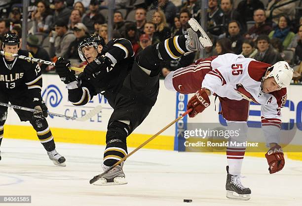 Right wing Landon Wilson of the Dallas Stars collides with Ed Jovanovski of the Phoenix Coyotes in the first period at the American Airlines Center...