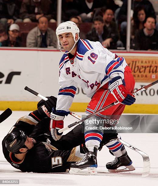 Scott Gomez of the New York Rangers gets tripped up with Ryan Getzlaf of the Anaheim Ducks during the game on December 16, 2008 at Honda Center in...