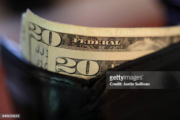 In this Photo Illustration, Twenty dollar bills sit in a wallet on August 29, 2017 in San Anselmo, California. The dollar fell to a two and a half...