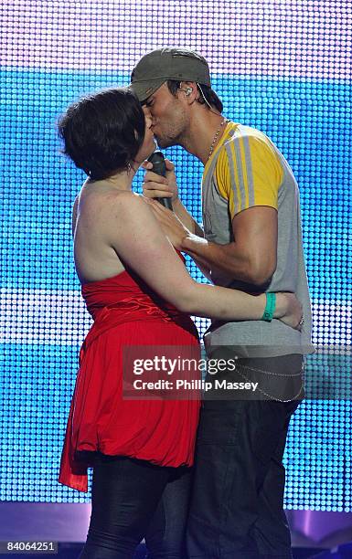 Enrique Iglesias performs with and kisses a 16 year old fan at the Cheerios Childline Concert in the The O2 on December 16, 2008 in Dublin, Ireland.