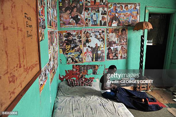 TooToo girl, a friend of the actors in the French movie 'Johnny Mad Dog' poses in a room at the Johnny Mad Dog Foundation in Monrovia on November 29,...