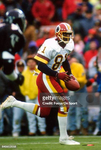 Art Monk of the Washington Redskins runs with the ball after catching a pass against the Atlanta Falcons during an NFL football game November 10,...
