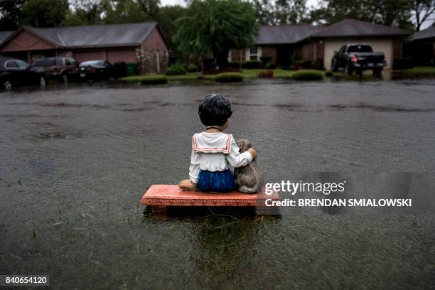Lawn ornament is seen on a flooded street during the aftermath of Hurricane Harvey August 29, 2017 in Houston, Texas. Harvey has set what forecasters...