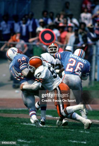 Earl Campbell of the Houston Oilers gets tackled by Clay Matthews Jr. #57 of the Cleveland Browns during an NFL game September 13, 1981 at Cleveland...