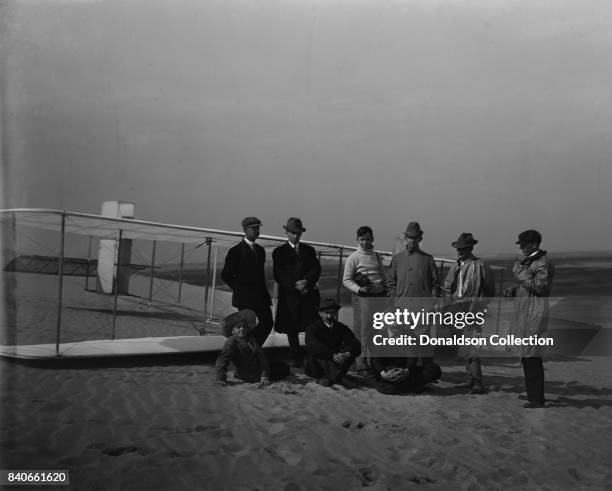 Group portrait in front of glider at Kill Devil Hill. Sitting: Horace Wright, Orville Wright, and Alexander Ogilvie; standing: Lorin Wright, and...