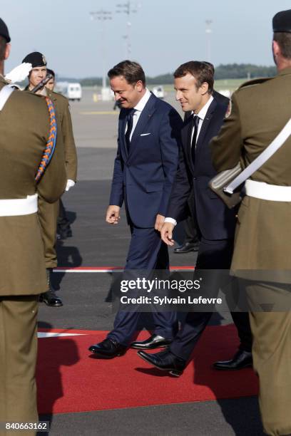 Luxembourg's Prime Minister Xavier Bettel welcomes French President Emmanuel Macron as he arrives at the airport for a one day state visit on August...