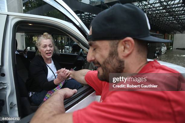 CaroLine Kirkpatrick of Salt Lake City, Utah, delivers a heartfelt thank you to rescue worker Adam Caballero after he carried her from the Omni...