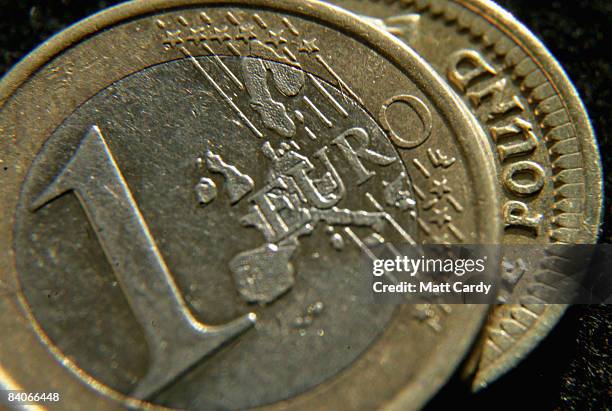 In this photo illustration, a British Pound coin lies under a Euro coin on December 17, 2008 in Bristol, England. The British Pound is currently at...