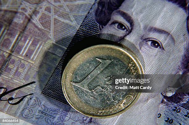 In this photo illustration a Euro coin is seen by a 20 GBP note on December 17, 2008 in Bristol, England. The British pound is currently at its...