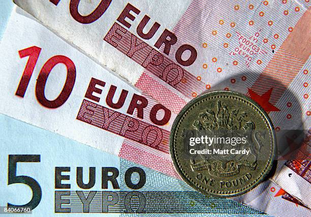 In this photo illustration, a British Pound coin is seen next to Euro notes on December 17, 2008 in Bristol, England. The British Pound is currently...