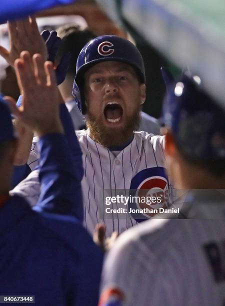 Ben Zobrist of the Chicago Cubs yells as he's greeted in the dugout after hitting a solo home run in the 6th inning against the Pittsburgh Pirates at...