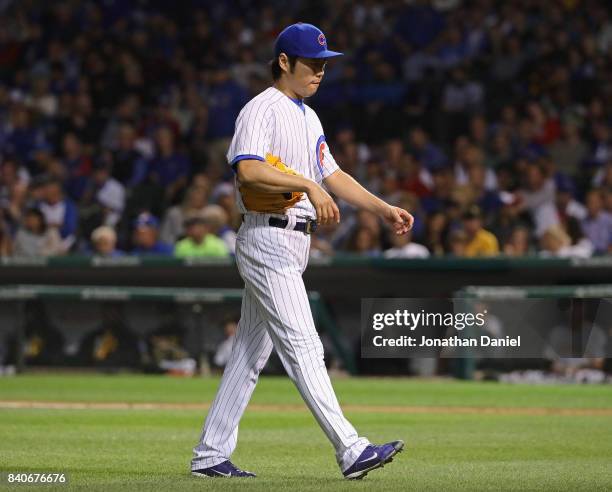 Koji Uehara of the Chicago Cubs walks to the dugout after being taken out of the game in the 7th inning against the Pittsburgh Pirates at Wrigley...