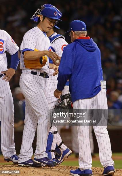 Koji Uehara of the Chicago Cubs is taken out of the game in the 7th inning by manager Joe Maddon against the Pittsburgh Pirates at Wrigley Field on...