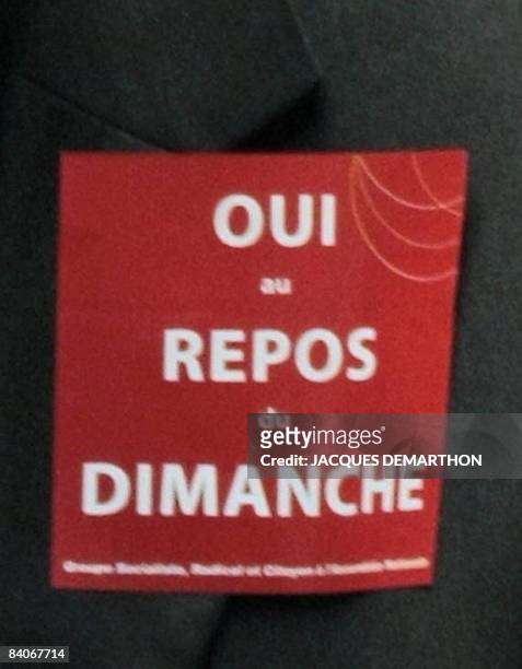 French socialist deputy Jean-Louis Bianco wears a sticker reading : 'Yes to the Sunday rest' on December 17, 2008 at the National Assembly in Paris...