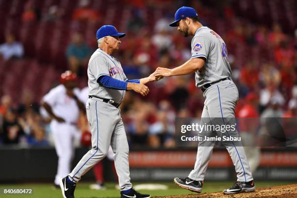 Josh Smoker of the New York Mets hands the ball to manager Terry Collins of the New York Mets as he is replaced at pitcher in the sixth inning...