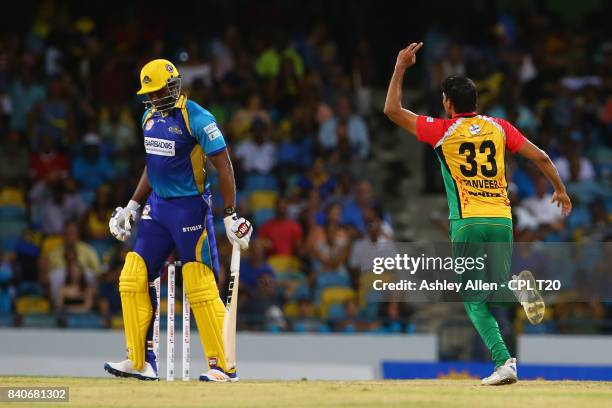 In this handout image provided by CPL T20, Kieron Pollard captain of Barbados Tridents is dismissed for 0 as Sohail Tanvir of the Guyana Amazon...