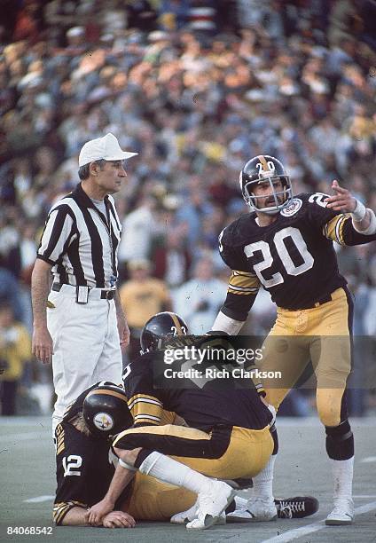 Super Bowl X: Pittsburgh Steelers QB Terry Bradshaw down on field, injured as Mike Wagner and Rocky Bleier call for help during game vs Dallas...