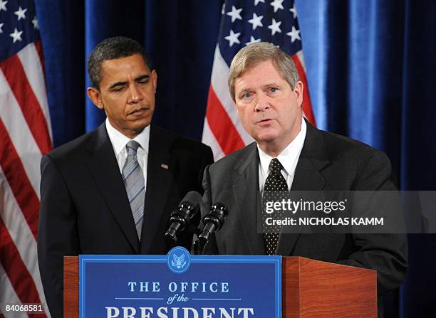 President-elect Barack Obama listens as agriculture secretary nominee Tom Vilsack speaks during a press conference in Chicago on December 17, 2008....