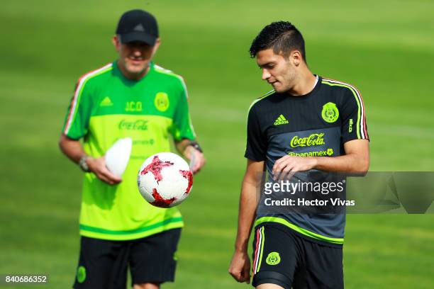 Raul Jimenez of Mexico controls the ball as his coach Juan Carlos Osorio looks on during a training session at Centenario Stadium on August 28, 2017...