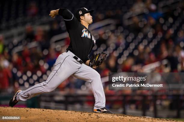 Junichi Tazawa of the Miami Marlins throws a pitch to a Washington Nationals batter in the seventh inning at Nationals Park on August 29, 2017 in...