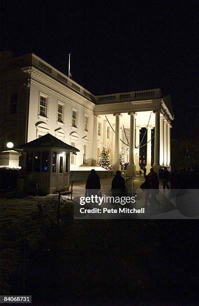 The White House after sunset, decorated for the holiday season.