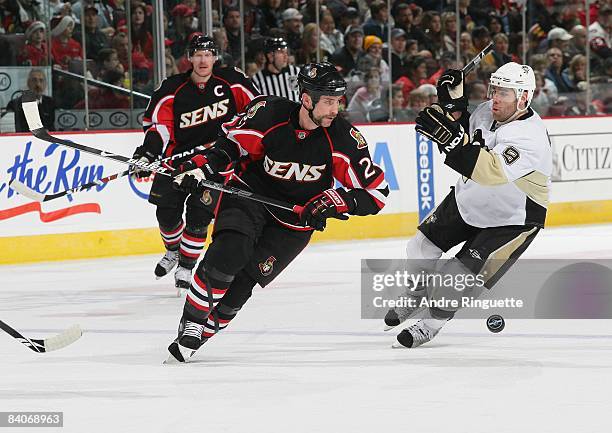 Jason Smith of the Ottawa Senators skates against Pascal Dupuis the Pittsburgh Penguins at Scotiabank Place on December 6, 2008 in Ottawa, Ontario,...