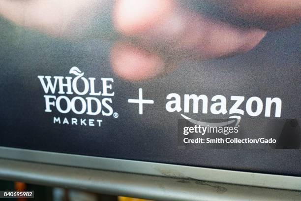 Signage at the Whole Foods Market store in San Ramon, California reading "Whole Foods Market and Amazon", announcing the acquisition of Whole Foods...