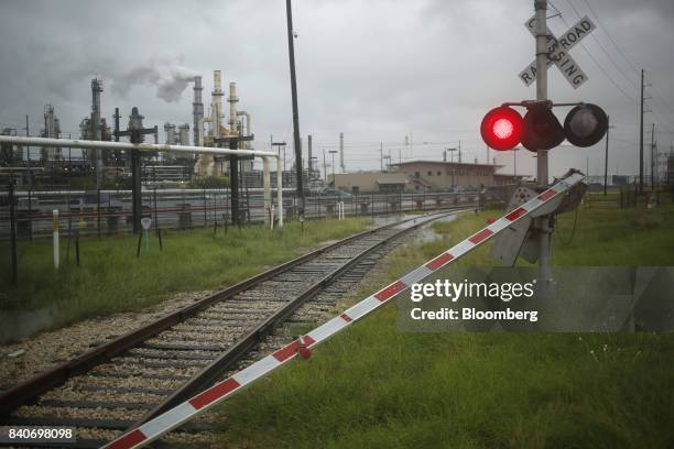 Damaged railroad crossing gate stands near the Valero Energy Corp. Oil refinery after Hurricane Harvey in Texas City, Texas, U.S., on Tuesday, Aug....