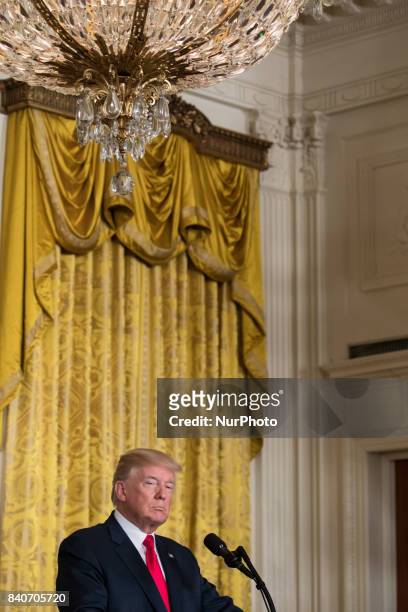 President Donald Trump listens, during his joint press conference with President Sauli Niinistö of the Republic of Finland, in the East Room of the...