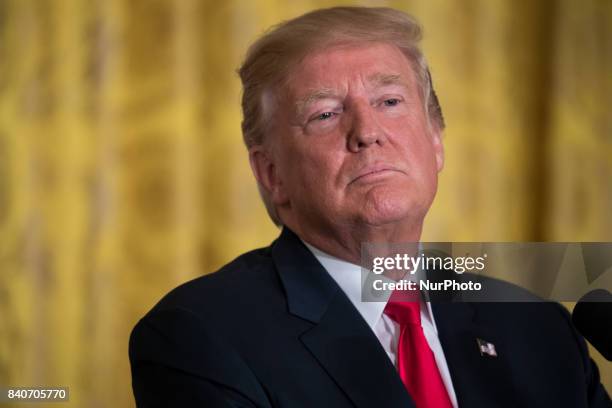 President Donald Trump listens during his joint press conference with President Sauli Niinistö of the Republic of Finland, in the East Room of the...