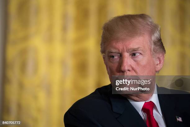 President Donald Trump listens during his joint press conference with President Sauli Niinistö of the Republic of Finland, in the East Room of the...