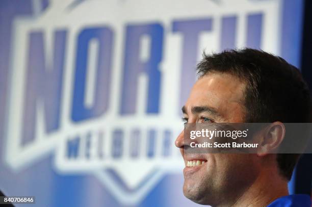 Brad Scott, coach of the Kangaroos smiles as he speaks to the media during a North Melbourne Kangaroos AFL press conference at the Arden Street...
