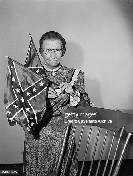 Irene Ryan holds up a pair of Confederate flags as Daisy Moses, the grandmother character in the television comedy 'The Beverly Hillbillies', 1965....