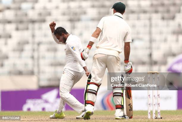 Shakib Al Hasan of Bangladesh celebrates taking the wicket of of Matthew Wade of Australia during day four of the First Test match between Bangladesh...