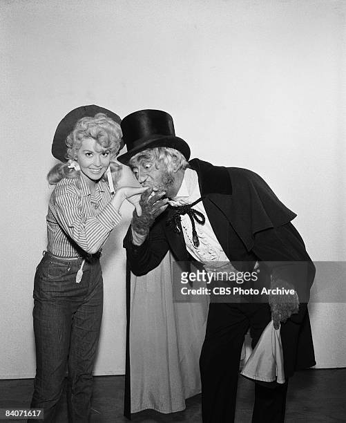 John Abbott as Sir Trevor Gielgud Burton-Guinness kisses the hand of Donna Douglas as Elly May, from The Beverly Hillbillies, 1964.