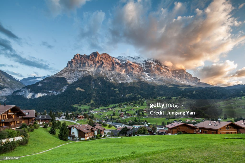 Grindelwald Village By Bernese Oberland Against Sky At Swiss Alps