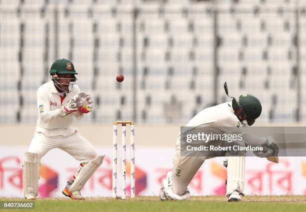 Nathan Lyon of Australia has his neck protector dislodged after a hit on the helmet from Shakib Al Hasan of Bangladesh during day four of the First...