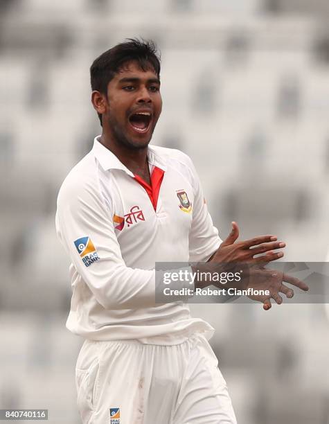 Mehedi Hasan Miraj of Bangladesh celebrates taking the wicket of Nathan Lyon of Australia during day four of the First Test match between Bangladesh...