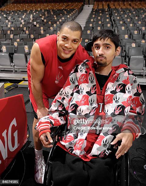 Anthony Parker of the Toronto Raptors poses with a fan from the Make-A-Wish Foundation prior to a game against the Dallas Mavericks at the Air Canada...