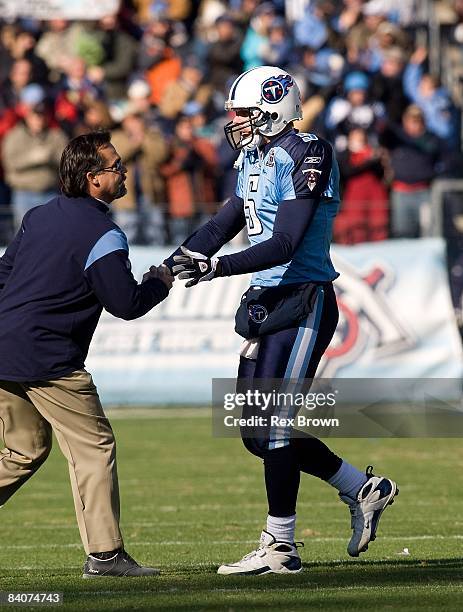 Kerry Collins of the Tennessee Titans is congratulated by head coach Jeff Fisher after a touchdown against the Cleveland Browns on December 7, 2008...