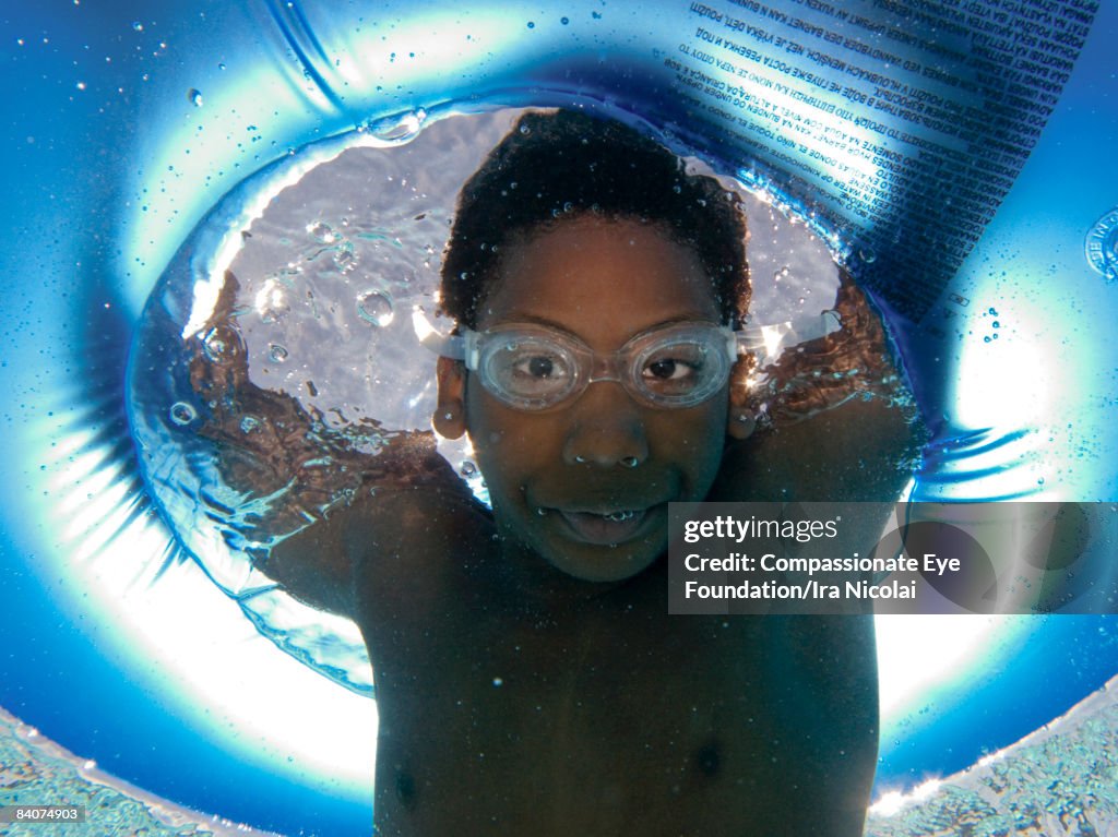 Boy in the pool holding his breath