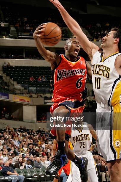 Jamal Crawford of the Golden State Warriors drives against Jeff Foster of the Indiana Pacers at Conseco Fieldhouse on December 18, 2008 in...