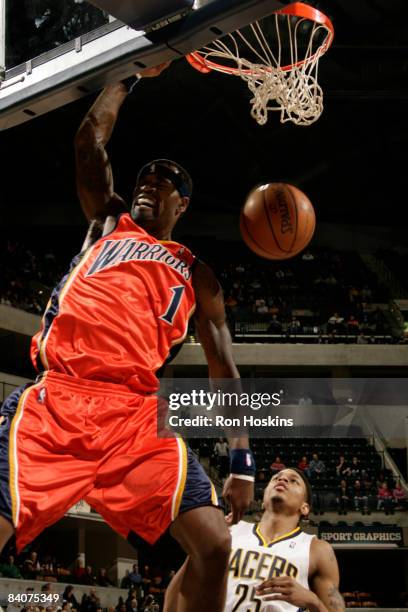 Stephen Jackson of the Golden State Warriors dunks over Brandon Rush of the Indiana Pacers at Conseco Fieldhouse on December 18, 2008 in...