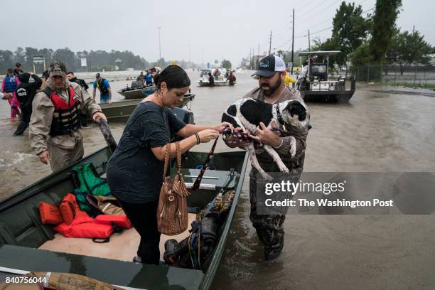 Volunteers in boats rescue people and their pets from their homes near interstate 45 in Houston, TX on Tuesday, Aug 29, 2017. Rising water from...