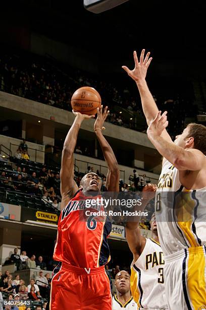 Jamal Crawford of the Golden State Warriors shoots over Rasho Nesterovic of the Indiana Pacers at Conseco Fieldhouse on December 18, 2008 in...