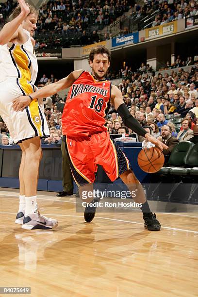 Marco Belinelli of the Golden State Warriors drives past Rasho Nesterovic of the Indiana Pacers at Conseco Fieldhouse on December 18, 2008 in...