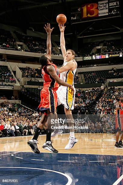 Rasho Nesterovic of the Indiana Pacers shoots over Ronny Turiaf of the Golden State Warriors at Conseco Fieldhouse on December 18, 2008 in...