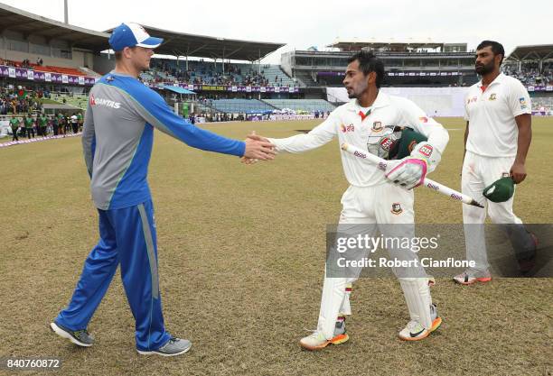 Steve Smith of Australia and Mushfiqur Rahim of Bangladesh shake hands after Bangladesh defeated Australia during day four of the First Test match...